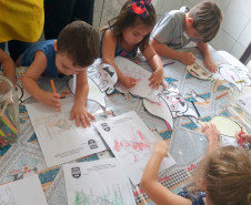 Diversas crianças colorindo desenhos de cães da polícia civil