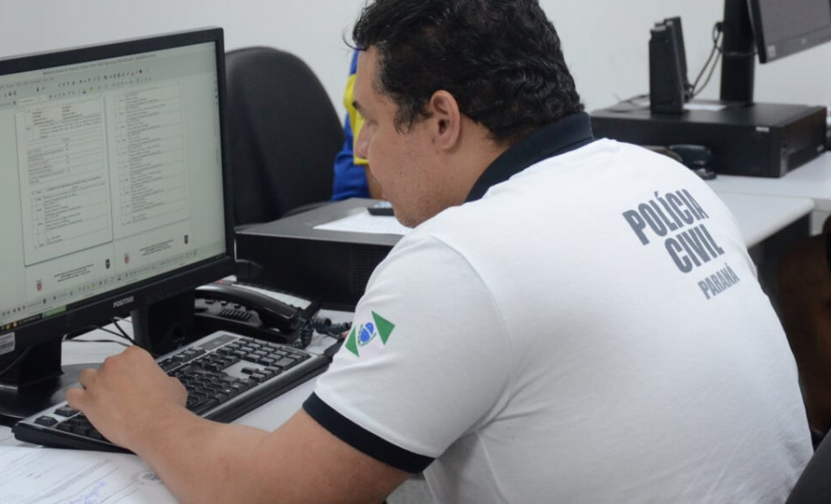 Policial lendo informações no computador