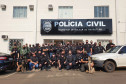 Dezenas de policiais civis posando para foto em frente à delegacia