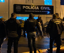 Policiais civis reunidos em frente à delegacia, recebendo instruções para a operação