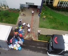 Fotografia aérea do momento em que caminhão da Defesa Civil está sendo carregado com os mantimentos doados