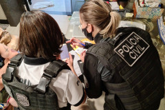 Policiais civis analisando materiais