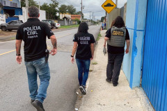 Policiais civis de costas, andando