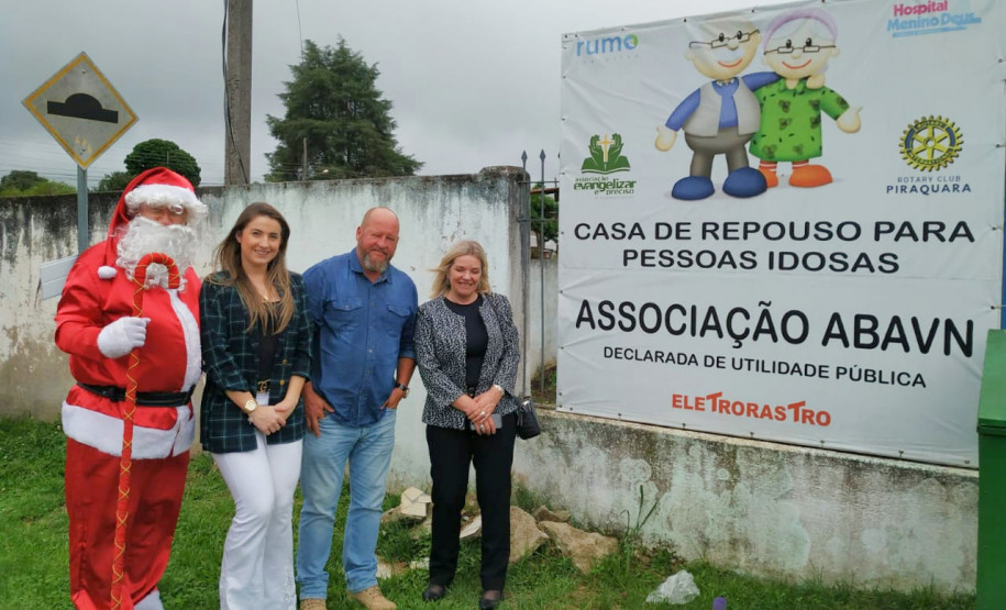 Policiais Civis e papai Noel em frente a casa de repouso ABAVN