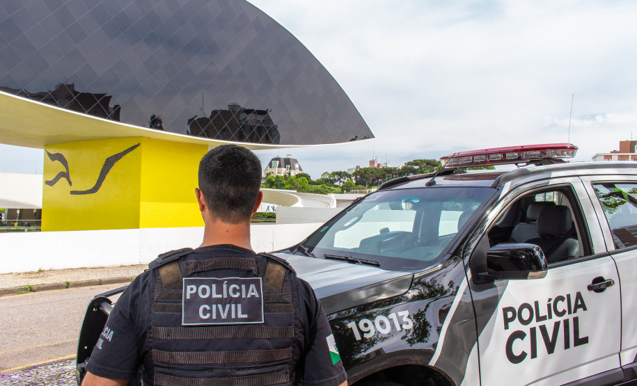 Policial civil e viatura em frente ao Museu Oscar Niemeyer em Curitiba