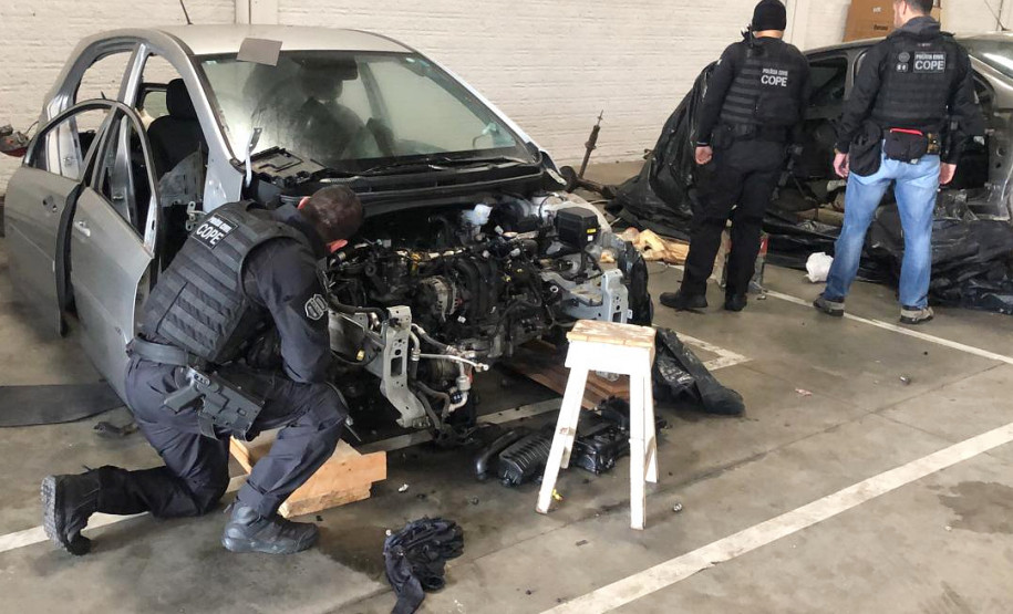 Policiais civis averiguando veículos
