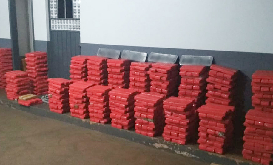 Diversos tabletes de droga empilhados no chão