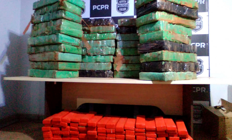 Tabletes da droga apreendida, no chão e sobre uma mesa