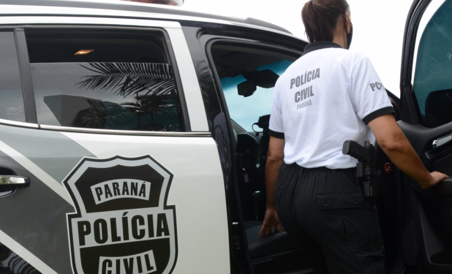 Policial civil entrando em viatura