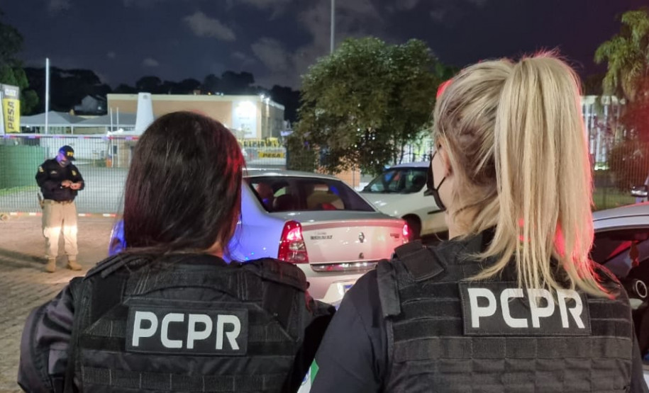 Policiais civis aparecem próximo à veículo durante fiscalização na Capital